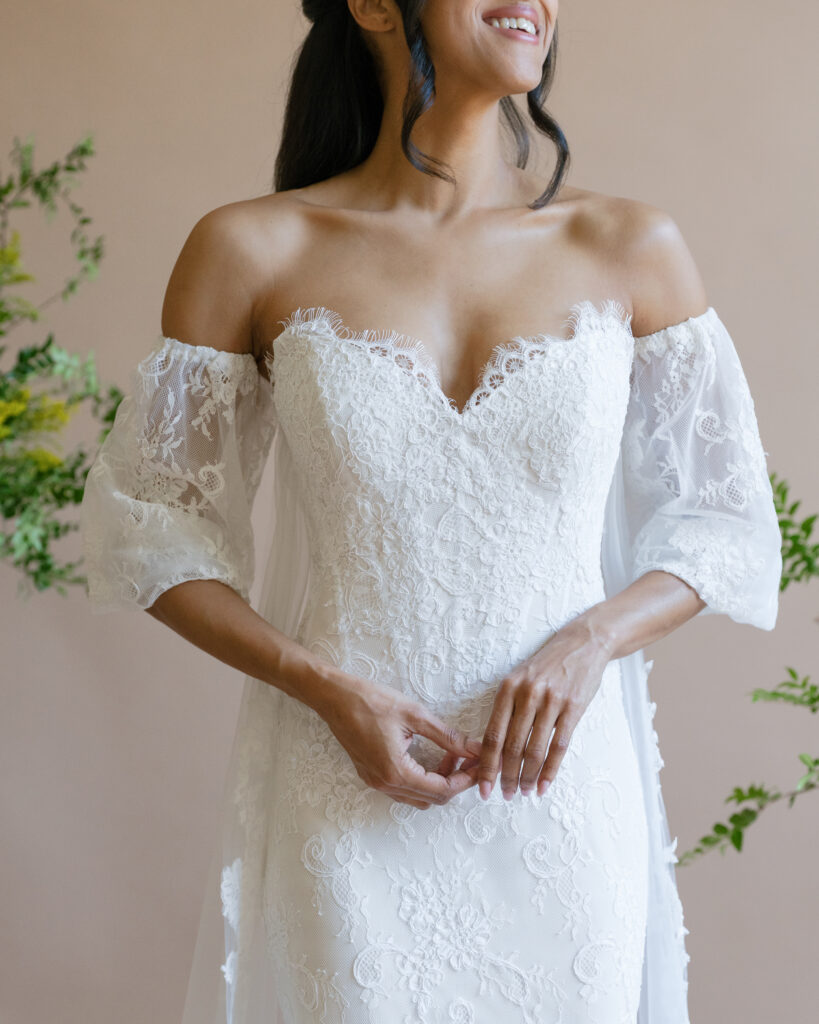 Fashion-forward editorial bridal photography highlighting a custom Lace & Liberty wedding dress with flowing movement.