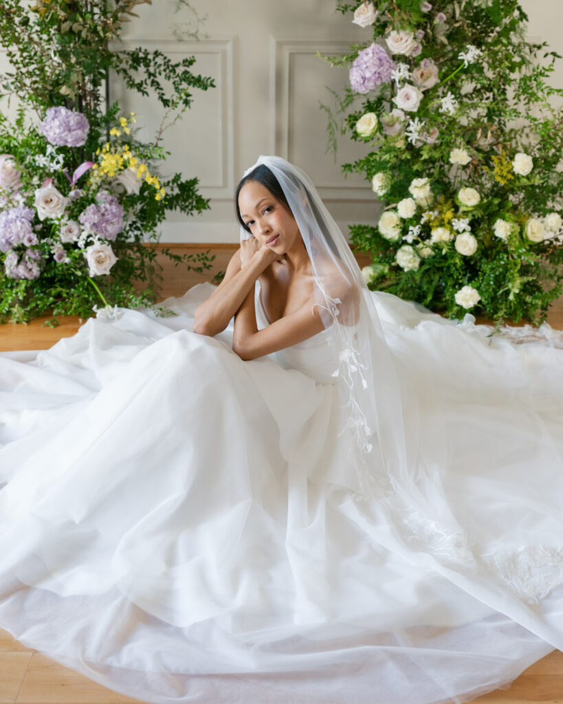 Luxury wedding photography showcasing modern editorial bridal style during a Lace & Liberty catalogue shoot showcasing a custom wedding gown on floral backdrop.